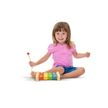 Child seated with a wooden xylophone mallet over colorful key blocks