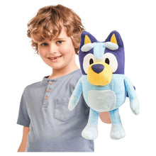 Bluey plush dog, light blue with navy ears and yellow muzzle, held by child