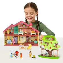 Children's home playset with red-roof house, figures, and green barbecue tree