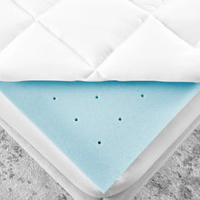 Blue memory foam core under white quilted mattress topper, corner view