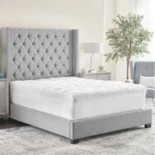 White quilted mattress topper on bed with stitched baffle edges