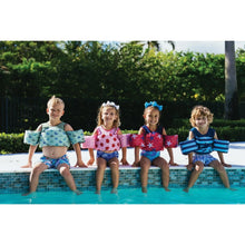 Kids life vests in pool, featuring blue shark and red starfish designs