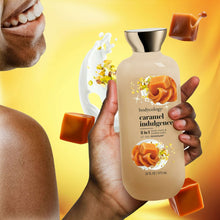 Bodycology caramel indulgence 2-in-1 body wash & bubble bath bottle held by hand