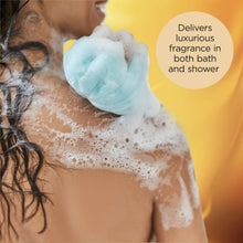 Lathering soap foam on skin and shoulder during shower, with blue-tinted bubbles