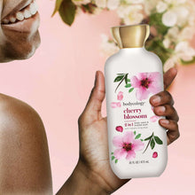 2-in-1 body wash & bubble bath bottle held in hands, cherry blossom label