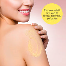 Exfoliating sugar scrub applied to skin on shoulder, with smiling woman face partially visible.