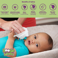 Saline nose wipe in an adult’s hand, cleaning a baby on a couch