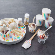 Glass dessert bowl with assorted ice cream, wafer pieces, and sprinkles