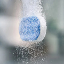 Blue cleaning granules splashing in a cloud, for espresso machine cleaning.