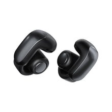 Bose Ultra open-ear earbuds, two black earbuds angled with speaker openings visible