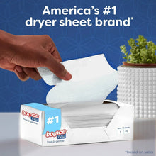 Hand pulling a dryer sheet from Bounce Select a Size free & gentle box