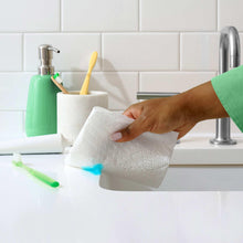 Bounty Advanced paper towel held in hand for wiping kitchen counter near sink