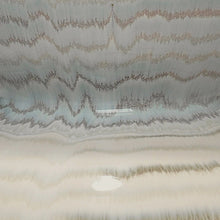 Ceramic lamp base with wavy ridges and light gray glaze texture