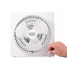 White box fan front with circular grille and knob being adjusted