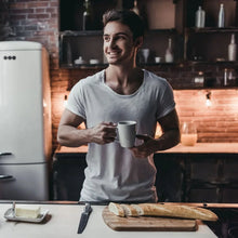 Dark roast coffee in a mug on a cafe table