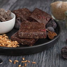 Dark fig & chocolate nutrition bar slices on dark plate
