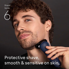 Electric foil shaver held on man’s neck with protective guard