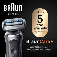 Electric shaver on a charging dock with rotating foil head, black and silver