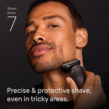 Men's electric foil shaver with ergonomic handle, used near the jaw