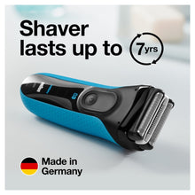 Electric shaver with turquoise grip and silver cutting head, side view.