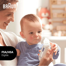 Adult using a white nasal aspirator with clear tip on a baby