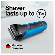 Electric shaver lying on its side with indicator light on handle