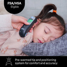 Black ear thermometer gently positioned in a sleeping child’s ear
