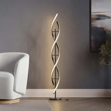 Vortex floor lamp with black spiral metal frame, three oval cutouts, black base
