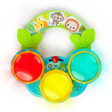 Top view of a safari musical drum toy with red, yellow, and blue drum pads in green frame