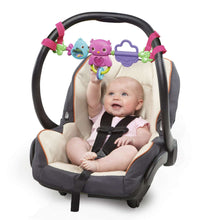 Baby carrier with overhead toy bar featuring two bird figures and a purple handle toy
