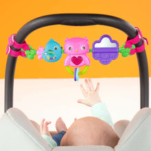 Overhead view of musical toy bar with blue and pink bird figures and purple handle