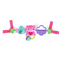 Musical take-along toy bar with pink and blue bird figures, purple handle, and ring