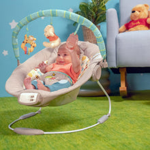 Baby bouncer seat with arched play frame and hanging Pooh-themed plush toys