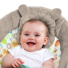 Baby bouncer with smiling baby in patterned seat and gray plush headrest