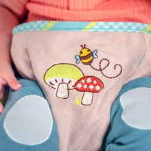 Embroidered bee and mushroom graphic on bouncer seat fabric