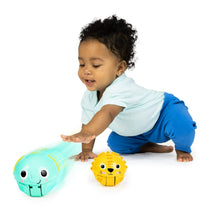 Baby crawling with a teal rolling animal ball and a yellow lion ball