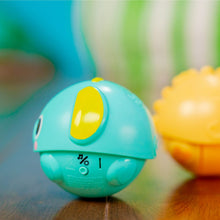 Teal rolling animal ball toy with yellow window and face details