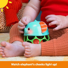 Teal elephant light-up rattle with orange patterned ear accents and smiling face