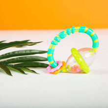 Grab-and-spin rattle/teether with turquoise-green ring and clear ball drum
