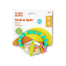 Grab-and-spin rattle and teether toy shown on retail box with colorful ring and clear drum