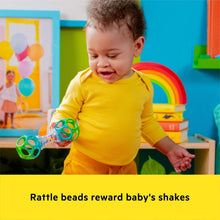 Baby shaking a colorful ring rattle ball with transparent bead chamber