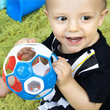 Blue and red baby rattle ball with white panels and dark round insert.