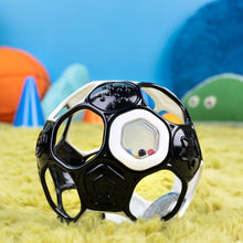 Black and white soccer ball rattle toy close-up with colorful bead windows