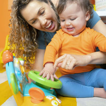 Toddler plays with Bright Starts driver learning toy, orange top and green wheel