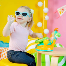 Baby plays with Bright Starts driver learning toy, teal and green steering wheel