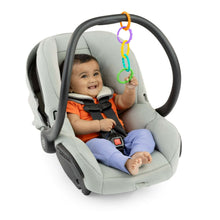 Baby in a car seat with colorful hanging link loop rings