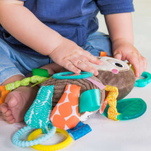 Sloth activity toy with textured panels, crinkly pieces, and colorful dangling straps