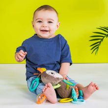 Baby playing with sloth take-along activity toy with dangling sensory rings