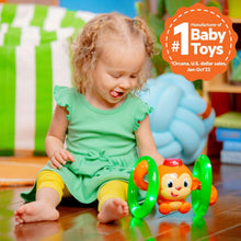 Monkey roll-and-glow baby toy with orange character and green glowing rolling rings