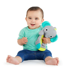 Gray elephant plush teether held by baby, with green fabric arms and crinkle